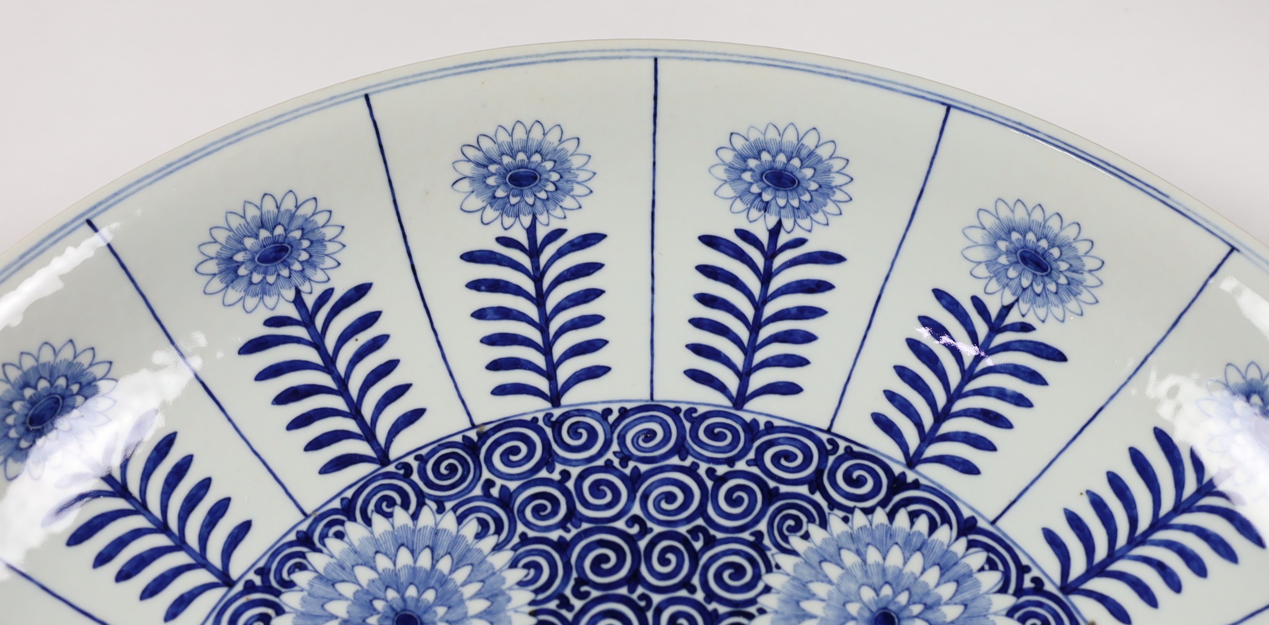 A pair of massive Chinese blue and white Aster pattern dishes, Kangxi mark but Republic period, 54.5cm diameter, one with a small section broken and restuck